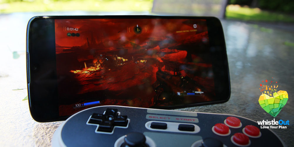 Moto z4 with a 3D game streaming and a gamepad outside