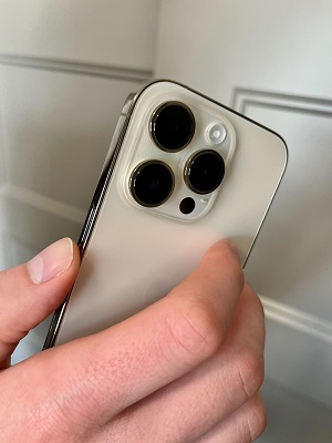 The Ultimate Guide to iPhone - hand holding iPhone with camera bump visible