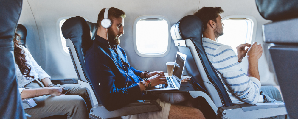 Man using Wi-Fi on airplane
