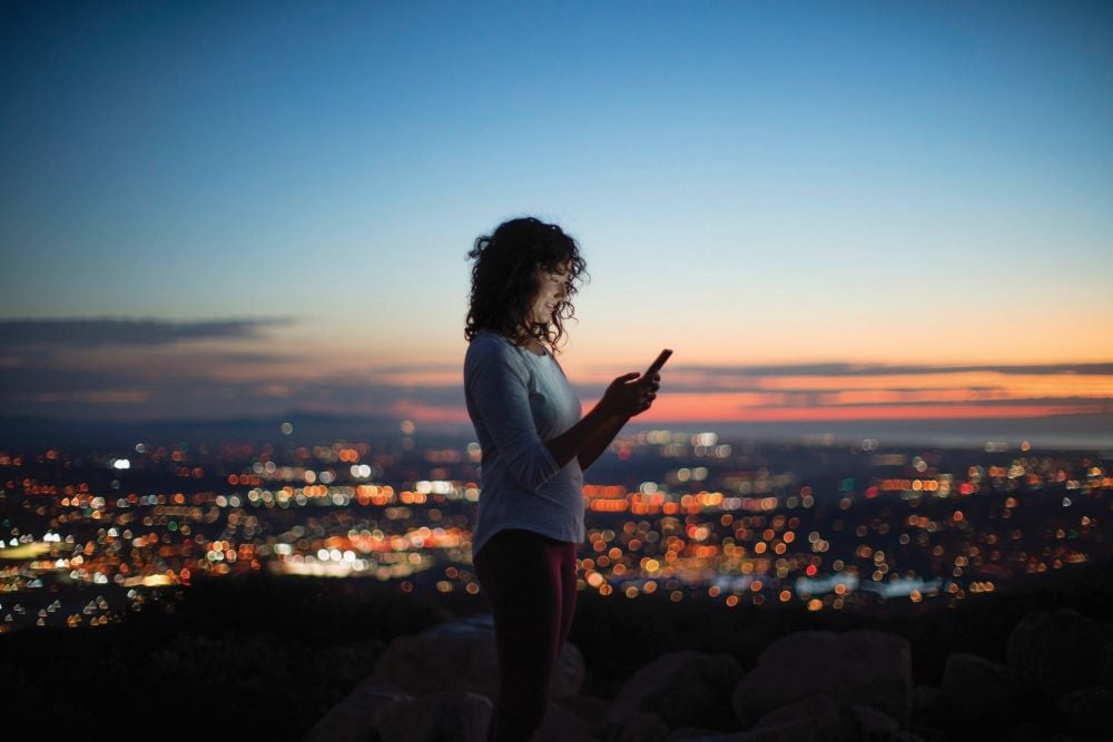 Woman using a smartphone at night.
