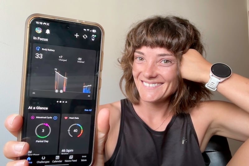 Jessica holing up the Garmin Connect app on her phone