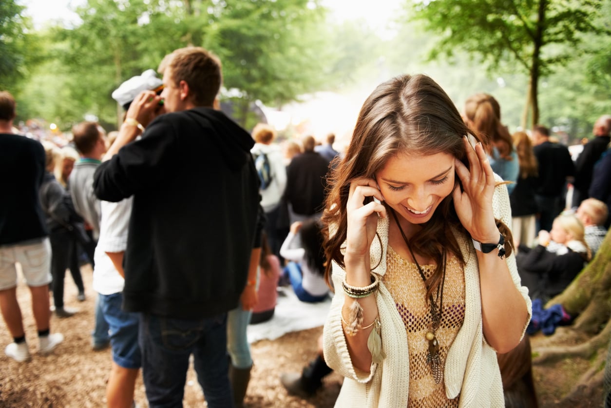 woman at a festival A woman talking on her phone at a music festival.