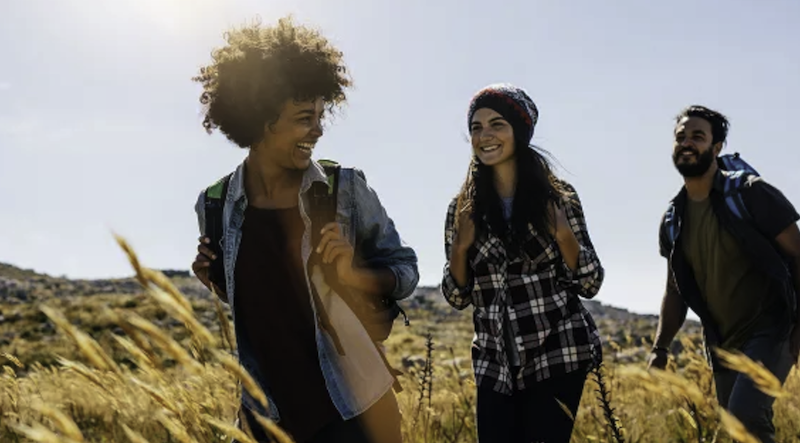 An image of a group of friends backpacking through the countryside.