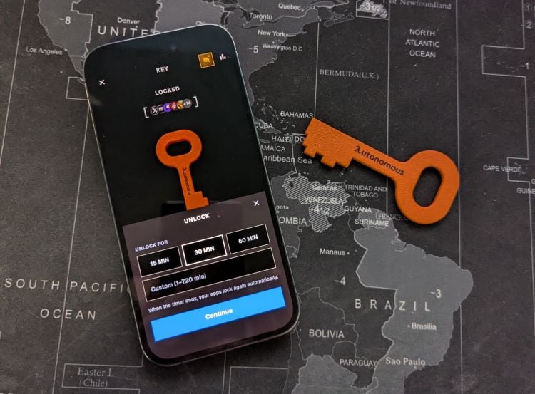 The Autonomous Key NFC device next to a smartphone showing the Autonomous app.
